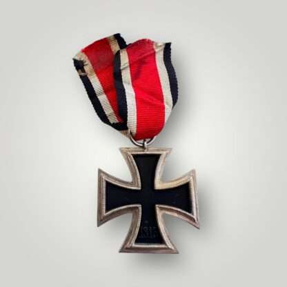 Reverse image of an Iron Cross 2nd Class Medal unmarked, with red, white, and black ribbon.