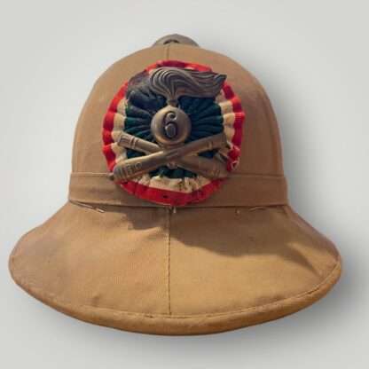 A frontal image of original WW2 Italian Colonial Helmet 6th Artillery Regiment pith helmet.