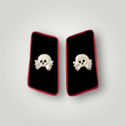 An original set of WW2 German Heer (Army) Panzer collar tabs complete with aluminium skulls on black woollen backing, edged with pink rayon pipping.