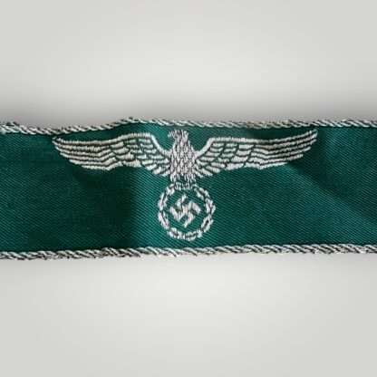 A WW2 German customs border police cuff title, machine embroidered on green rayon material.