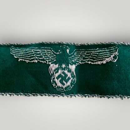 Reverse image of a WW2 German customs border police cuff title, machine embroidered on green rayon material.