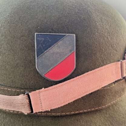 A National tri-color shield on German pith helmet.