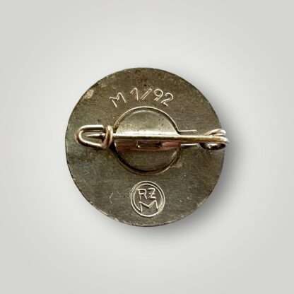 Reverse image of a NSDAP Party pin badge marked M1/92.