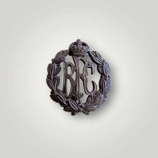 A British Royal Flying Corps officers collar badge manufactured in bronze, with the monogram 'RFC' surmounted by a King's crown and surrounded by a laurel wreath.