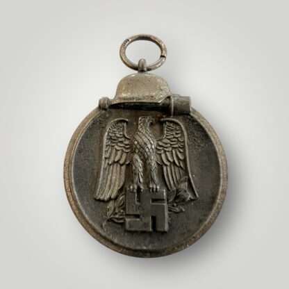 A German WW2 Eastern Front medal marked "127" on the medal ring attributed to the following manufacturer Moritz Hausch of Pforzheim.