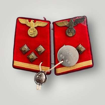 An original set of NSDAP collar tabs for Obereinsatzleiter with RZM tag, constructed on red doe skin backing with gilt national eagles cluching a wreathed swastika, with three gilt bronze rank pips with embroidered golden organge tresse below.