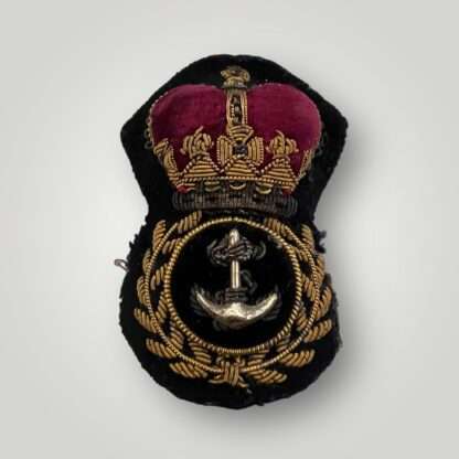 A British Royal Navy Petty Officer's visor cap badge, hand embroidered in bullion wire and felt.