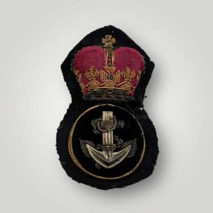 A British Royal Navy Petty Officer's cap badge post war, hand embroidered in bullion wire and felt.