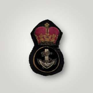 A British Royal Navy Petty Officer's cap badge post war, hand embroidered in bullion wire and felt.
