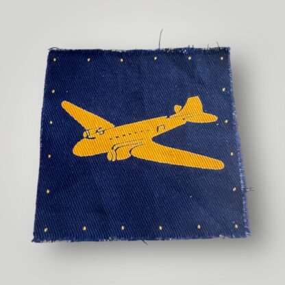 A British RASC WW2 Air Despatch Group Patch, constructed in cotton screen printed. The badge depicts a yellow 'Dakota' aircraft, on a royal blue backgroud.