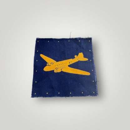 A British RASC WW2 Air Despatch Group Patch, constructed in cotton screen printed. The badge depicts a yellow 'Dakota' aircraft, on a royal blue backgroud.