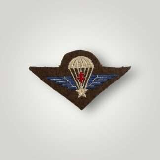 A rare Free French Groupe Commando De France parachute wings, machine embroiderd in blue, white, and red thread on khaki woolen backing.