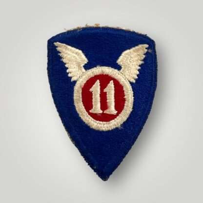 A US WW2 Army 11th Airborne Divisional patch, machine embroidered in white and red thread on blue backing.
