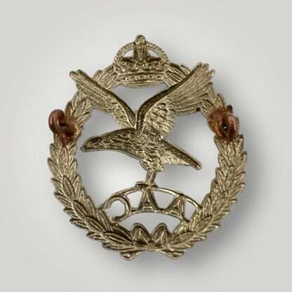 Reverse image of a British WW2 Army Air Corp Cap Badge with a voided crown, die-stamped in white metal.