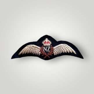 A Royal New Zealand WW2 pilot wings, embroidered pair of outstretched wings supporting a central laurel wreath with the 'NF' monogram in the centre for New Zealand surmounted by King's crown.