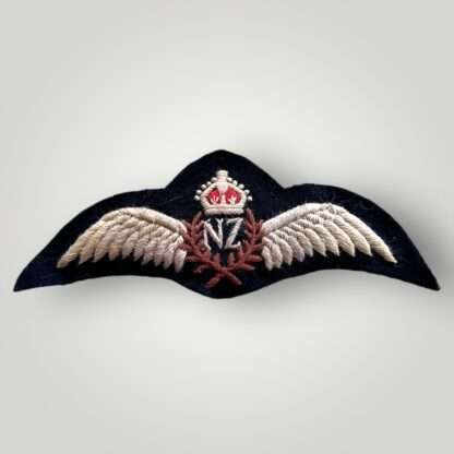 A genuine Royal New Zealand WW2 pilot wings, embroidered pair of outstretched wings supporting a central laurel wreath with the 'NF' monogram in the centre for New Zealand surmounted by King's crown.