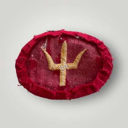 A reverse image of a British Army WW2 44th Division formation patch, machine embroidered in yellow thread on red cotton backing.