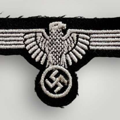 A Waffen-SS EM/NCO's Sleeve Badge, machine embroidered with silver grey thread on black wool backing.