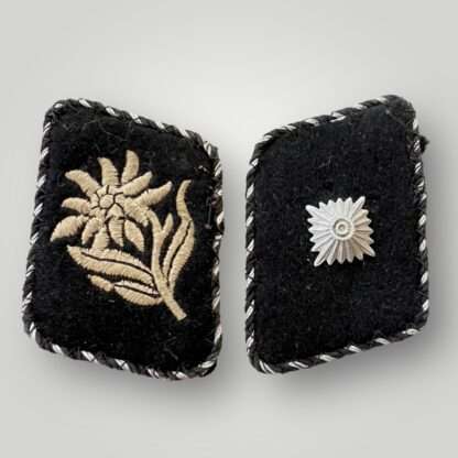 A rare matching pair of Allgemeine SS Unterscharführer collar tabs for SS Fuss Standarte 87 Innsbruck (Austria), hand embroidered in silver grey thread on black wool backing, with black and aluminum twisted cord pipping.