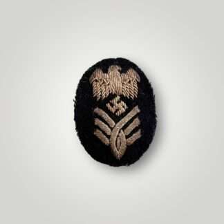 A Kriegsmarine High Grade Administration Official's sleeve badge, hand embroidered in silver bullion.