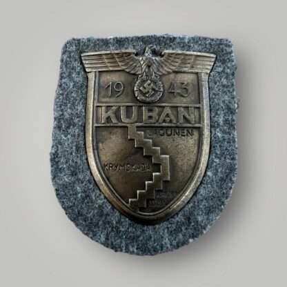 An original Heer Kuban shield, die stamped construction in bronze complete with field grey woollen backing.