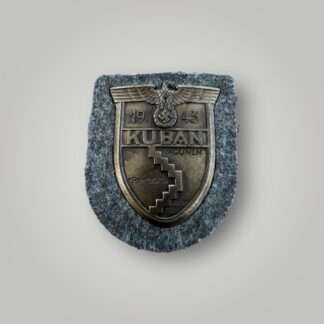 An original Heer Kuban shield, die stamped construction in bronze complete with field grey woollen backing.