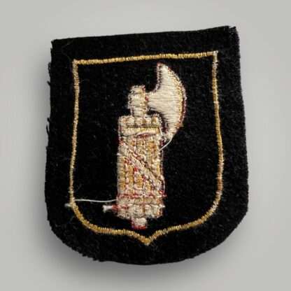 Reverse image of an SS Italian Volunteer Sleeve Badge, machine embroidered on red and yellow thread on black wool backing.