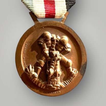 Reverse image of a WW2 German German Italian Campaign Medal in bronze, complete with the original ribbon.