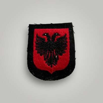 An original Albanian SS Volunteer Sleeve Shield, machine embroidered in red and black thread depicting the Albanian eagle.