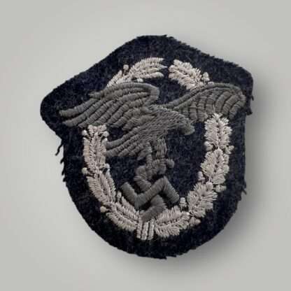 A WW2 German Luftwaffe Observers embroidered badge, constructed on blue-grey wool backing.