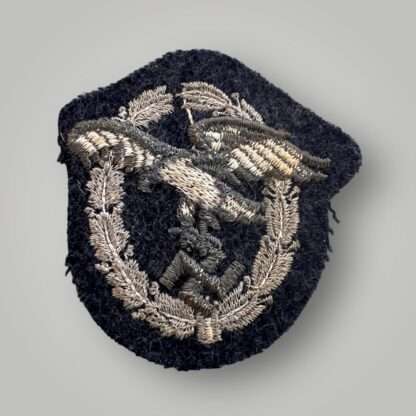 Reverse image of an WW2 German Luftwaffe Observers embroidered badge, constructed on blue-grey wool backing.