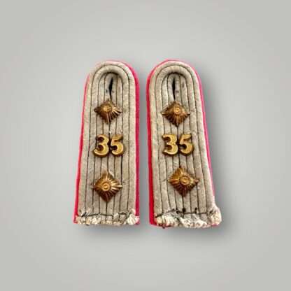 A set of Heer Panzer-Regiment 35 WW2 shoulder boards for captain, constructed in a silver aluminum braid with gothic unit number "35" and two gilt pips above and below.