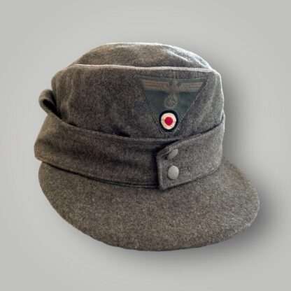 An orginal WW2 German Heer M43 Officers field cap, constructed in grey field grey wool with aluminium wire piping running around the top of the outer edge of the crown.