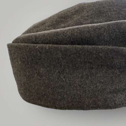 A side view image of a German Heer M43 Officers field cap, with aluminium wire piping.