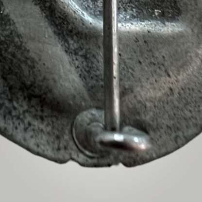 A close up image of the reverse set up of a WW2 German Panzer Assault Badge Silver by Rudolf Karneth, Gablonz, catch.