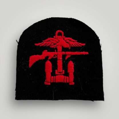 A British WW2 Royal Navy / Royal Marines Combined Operations badge, tombstone shaped badge machine embroiderd in red thread on dark blue woollen backing.