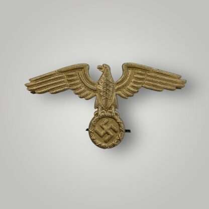Reich Ministry of Eastern Territories visor cap insignia, die stamp construction in aluminium with gilt finish.