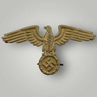 An original Reich Ministry of Eastern Territories visor cap insignia, die stamp construction in aluminium with gilt finish.