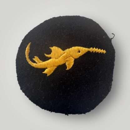 An extremly rare Kriegsmarine Combat Badge for small combat units probationary level, machine embroidered in yellow thread on dark blue wool which depicts a sawfish.