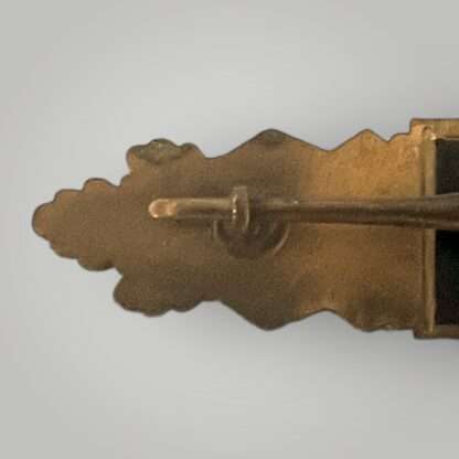 A close up image of an original late war WW2 German Close Combat Clasp in Bronze by Steinhauer & Lück, catch.