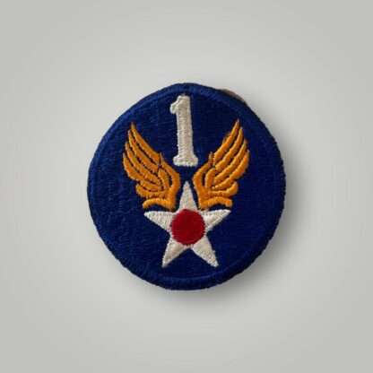 An original 1st USAAF badge, machine embroidered in white, red, and yellow thread on blue backing.