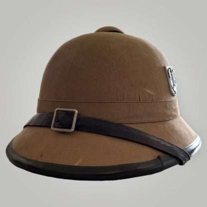 A Heer captured tropical pith helmet, constructed in cork covered in khaki coloured cotton, with dark brown leather chip strap.
