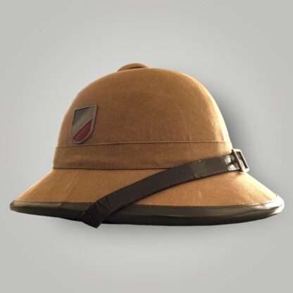 A Heer captured tropical pith helmet, constructed in cork covered in khaki coloured cotton, with dark brown leather chip strap.