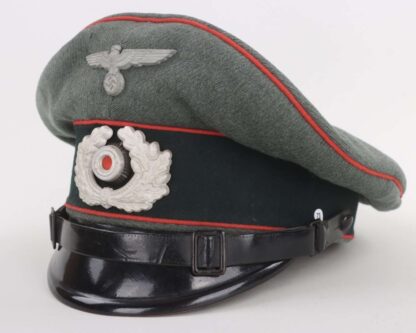An early Heer Flak EM/NCOs Visor Cap By Wilhelm Wethekam, constructed with grey-green felted doeskin with three bands of red pipping for Flak/Artillery units with dark green woolen band for Army/Heer and leather chin strap.