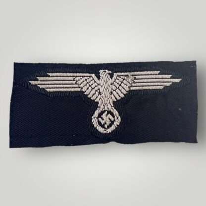 A genuine Waffen-SS cap eagle, BeVo flat woven construction in white thread on black rayon.