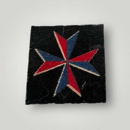 A WW2 British Malta Mobile Units Royal Artillery Formation Badge, machine embroidered in blue and red thread on black backing.