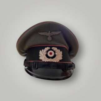 An original WW2 German (Heer) Panzer EM/NCO's visor cap, constructed in grey-green doeskin with three bands of pink pipping for Panzer units and dark green woolen band for Army/Heer with black leather chin strap.
