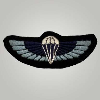 A rare late war British WW2 Special Air Service (SAS) parachutist wings, hand embroidered in Oxford blue, dark blue, black, white thread on black  backing.
