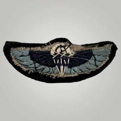 Reverse image of a rare late war British WW2 Special Air Service (SAS) parachutist wings, hand embroidered in Oxford blue, dark blue, black, white thread on black  backing.