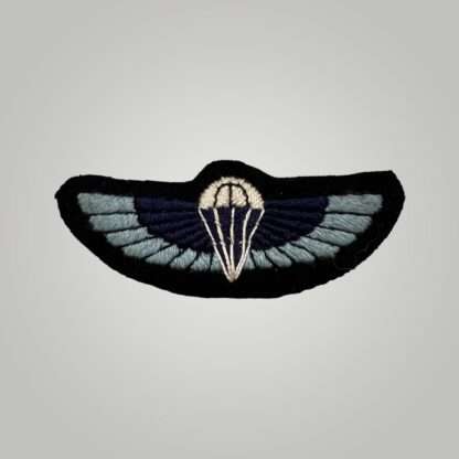 A rare late war British WW2 Special Air Service (SAS) parachutist wings, hand embroidered in Oxford blue, dark blue, black, white thread on black  backing.